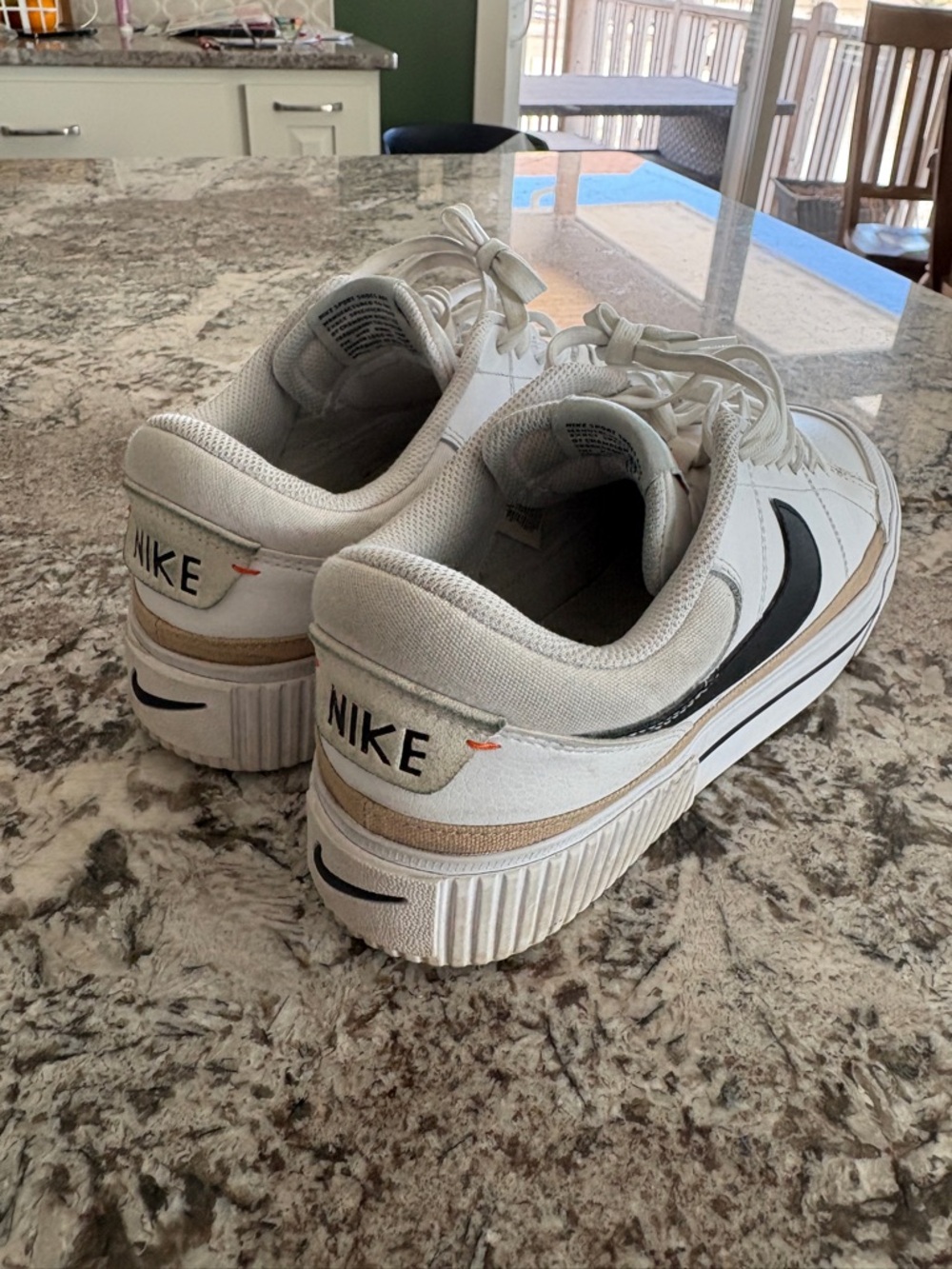 Nike White Sneakers with Black Swoosh and Tan Accent